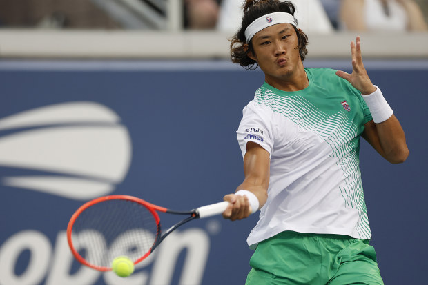 Zhizhen Zhang of China returns a shot against Casper Ruud of Norway during their second round match.