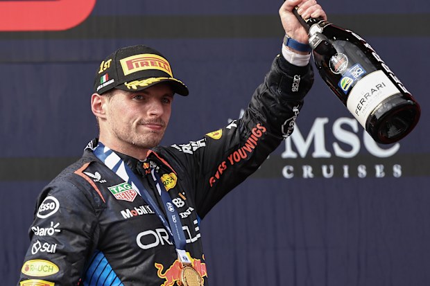 Max Verstappen of the Netherlands and Oracle Red Bull Racing celebrates his win on the podium during the F1 Grand Prix of Emilia-Romagna at Autodromo Enzo e Dino Ferrari Circuit on May 19, 2024 in Imola, Italy.(Photo by Qian Jun/MB Media/Getty Images)
