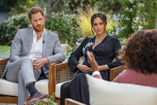 This image provided by Harpo Productions shows Prince Harry, from left, and Meghan, The Duchess of Sussex, in conversation with Oprah Winfrey. (Joe Pugliese/Harpo Productions via AP)
