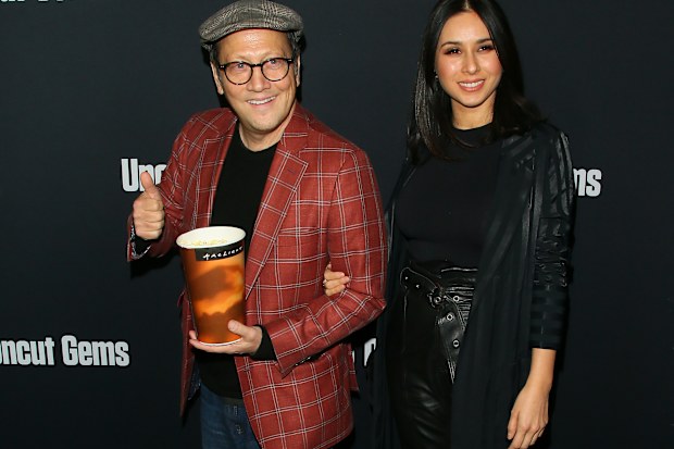Rob Schneider and Patricia Azarcoya Schneider attend the premiere of A24's "Uncut Gems" at The Dome at Arclight Hollywood on December 11, 2019 in Hollywood, California.