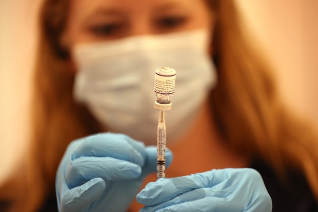 Safeway pharmacist Ashley McGee fills a syringe with the Pfizer COVID-19 booster vaccination at a vaccination booster shot clinic on October 01, 2021 in San Rafael, California. 
