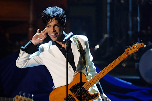 Prince performs after being inducted into the Rock and Roll Hall of Fame in 2004.