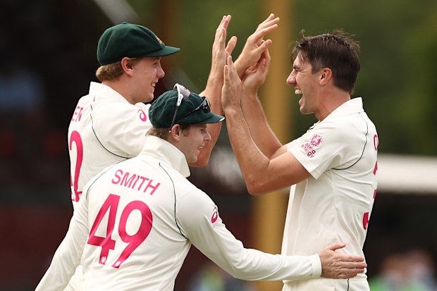Pat Cummins and Cameron Green of Australia celebrate after taking the wicket of Shubman Gill of India.