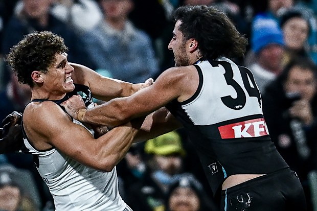 Charlie Curnow of the Blues fights with Lachie Jones of the Power.