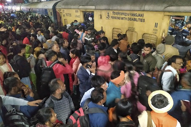 At least 15 people, including 10 women and three children, were killed in a crowd crush at a New Delhi railway station Saturday as passengers tried to board trains heading to the world's largest religious gathering, according to Indian media.
