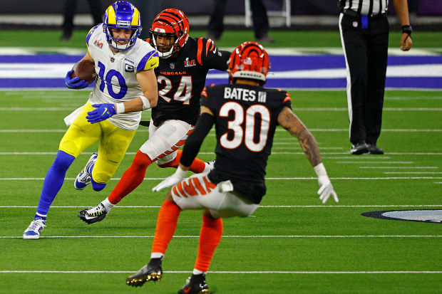 Cooper Kupp #10 of the Los Angeles Rams runs with the ball as Jessie Bates #30 and Vonn Bell #24 of the Cincinnati Bengals defend in the fourth quarter during Super Bowl LVI at SoFi Stadium on February 13, 2022 in Inglewood, California. (Photo by Ronald Martinez/Getty Images)