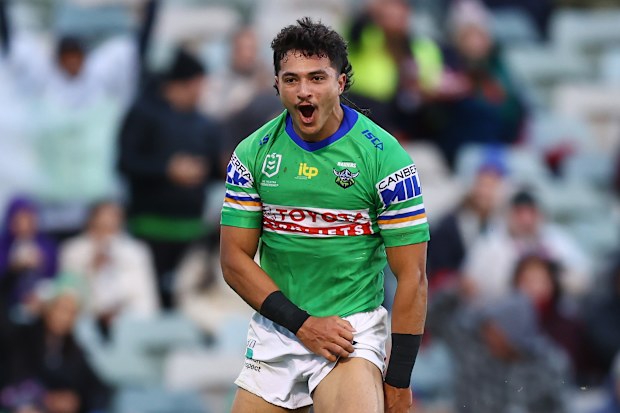 Xavier Savage of the Raiders celebrates scoring a try.