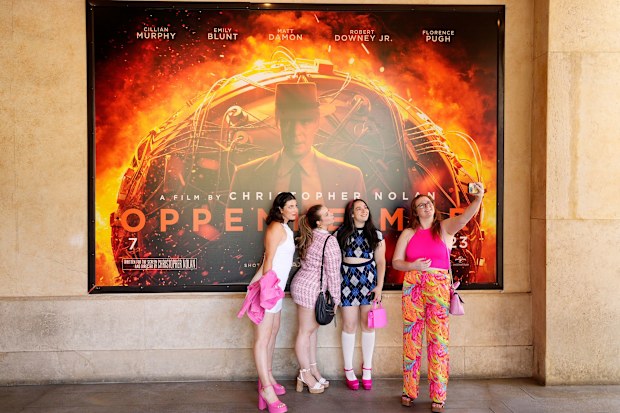 "Barbenheimer" viewers dressed like Barbie to see "Oppenheimer" in this photo from the opening weekend of both films last July. It was common to see moviegoers rocking pink, even to see the intense biopic, to the theater for weeks after the films' release.