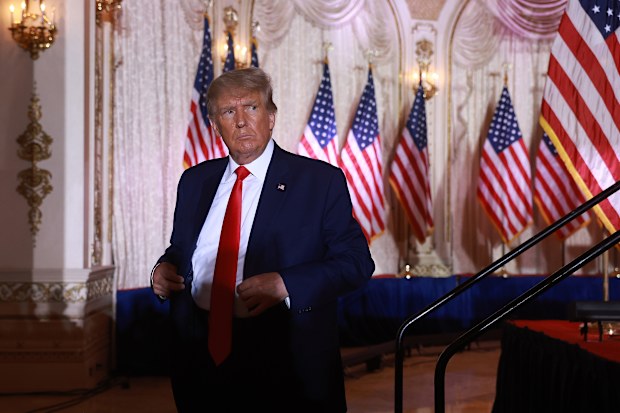 Former US President Donald Trump leaves the stage after speaking during an event at his Mar-a-Lago home on November 15, 2022 in Palm Beach, Florida.