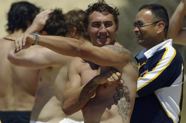Mat Rogers and Eddie Jones enjoy the sun at Diggers Beach in Coffs Harbour.