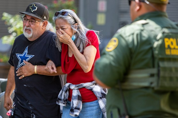 A woman cries Tuesday May 24, 2022 as she leaves the Uvalde Civic Center. 
