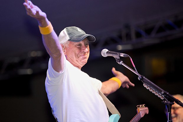 Singer/songwriter Jimmy Buffett finishes a song at the Parrot Heads Meeting of the Minds convention in Key West, Florida on Nov. 5, 2015