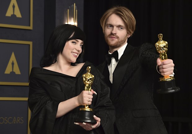 Billie Eilish, left, and Finneas, winner of the award for best original song for "No Tie To Die" from "No Time To Die", pose in the press room at the Oscars on Sunday, March 27, 2022, at the Dolby Theatre in Los Angeles. 