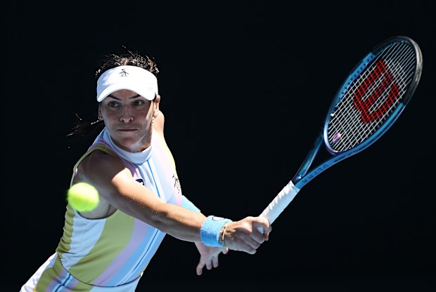 Ajla Tomljanovic of Australia plays a backhand against Ashlyn Krueger.