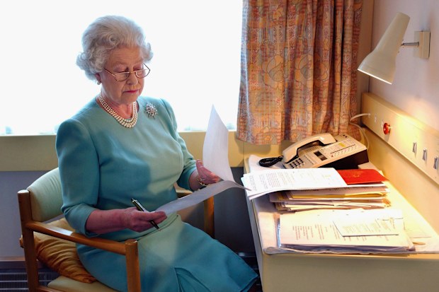 Queen Elizabeth works at her desk on the Royal Train in May, 2002. ©anwarhussein.com