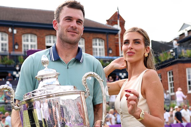 Tommy Paul and Paige Lorenze pose with the cinch Championships 2024 winners trophy following victory against Lorenzo Musetti of Italy in the Men's Singles Final match of the cinch Championship at The Queen's Club on June 23, 2024 in London, England. 