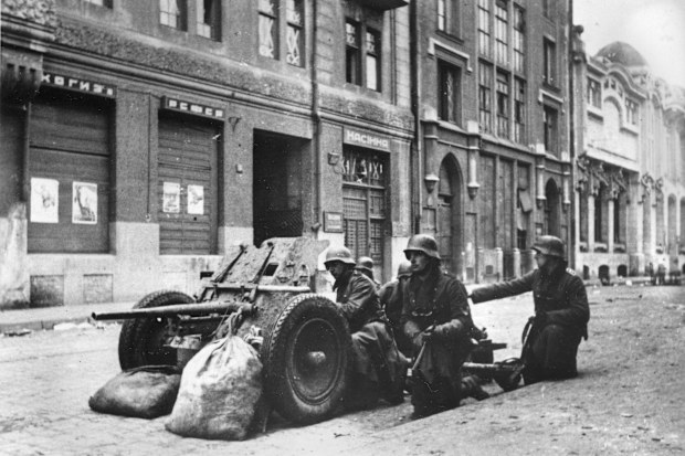 A German anti-tank artillery crew is shown in position in a street of the Russian industrial city Kharkov in the Ukraine during Nazi occupation, Dec. 15, 1941 during World War II.  War posters appear on the building at left.  (AP Photo)
