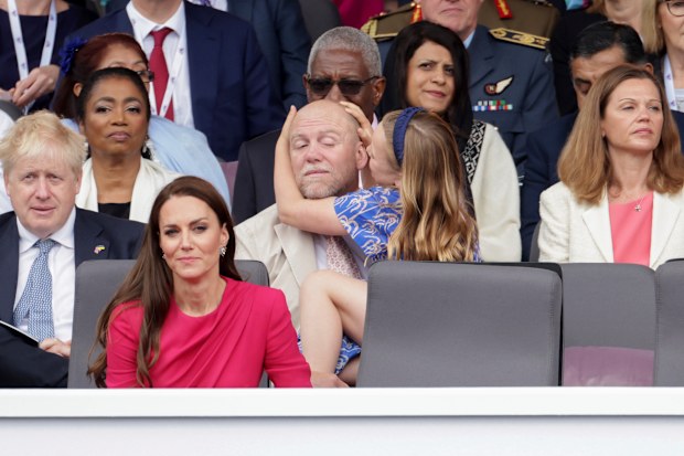 Mia Tindall rearranged her dad, Mike Tindall's very sparse haircut as they watch the Platinum Jubilee Pageant outside Buckingham Palace in London, Sunday June 5, 2022.