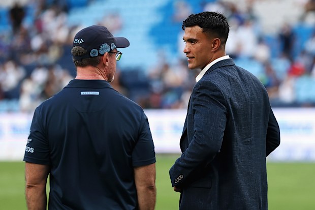 Waratahs coach Dan McKellar talks to Joseph-Aukuso Suaalii at Allianz Stadium.