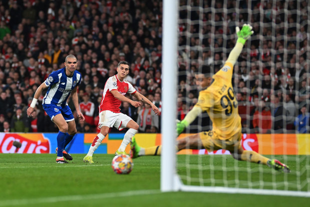 Leandro Trossard of Arsenal scores his team's first goal past Diego Costa of FC Porto.