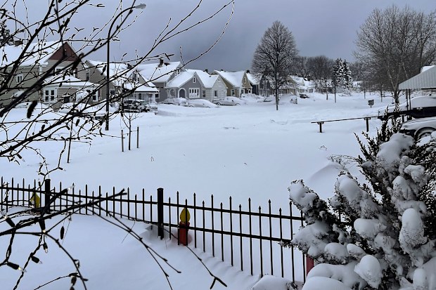 Snow blankets a neighborhood, Sunday, Dec. 25, 2022, in Buffalo, N.Y. Millions of people hunkered down against a deep freeze Sunday morning to ride out the frigid storm that has killed at least 24 people across the United States and is expected to claim more lives after trapping some residents inside houses with heaping snow drifts and knocking out power to several hundred thousand homes and businesses. (AP Photo/Carolyn Thompson)