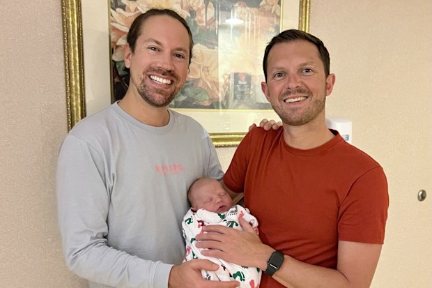 Ben Harris and Danny Cowan with their son Lachlan as a newborn.