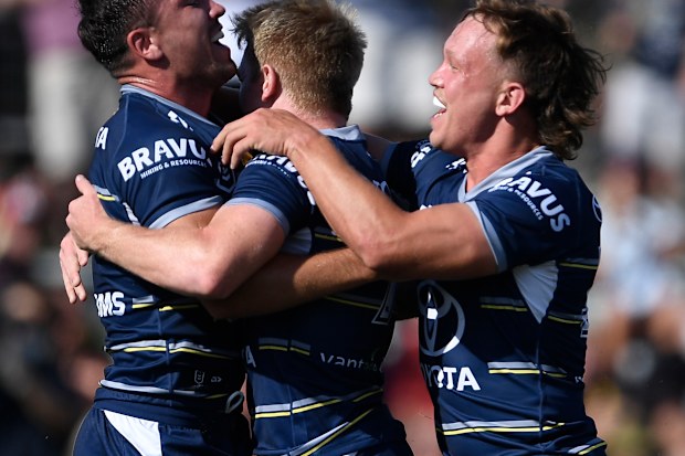 Reece Robson (left) of the Cowboys celebrates after scoring a try with Reuben Cotter.