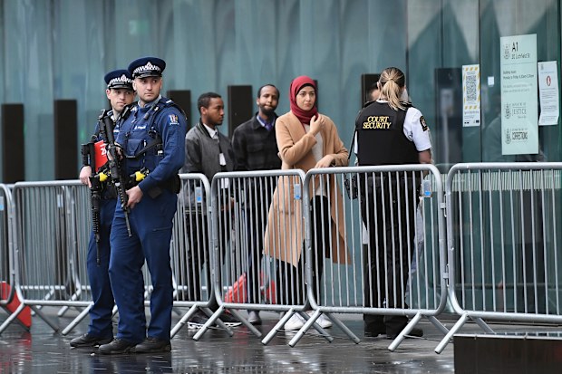 Armed police officers are seen in front of Christchurch High Court as victims arrive for the sentencing hearing of Brenton Harrison Tarrant