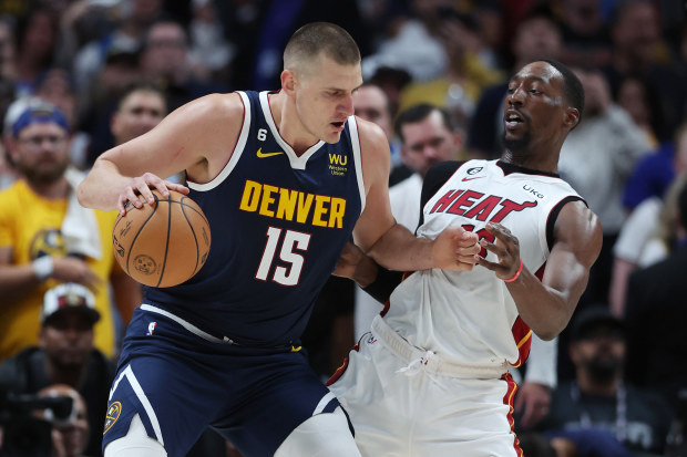 DENVER, COLORADO - JUNE 04: Nikola Jokic #15 of the Denver Nuggets drives to the basket against Bam Adebayo #13 of the Miami Heat during the first quarter in Game Two of the 2023 NBA Finals at Ball Arena on June 04, 2023 in Denver, Colorado. (Photo by Matthew Stockman/Getty Images)