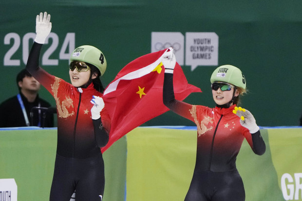 Li Jinzi (left) and Yang Jingru of China celebrate with their national flag in the final of the women's 1000m short track speed skating during the Winter Youth Olympic Games.