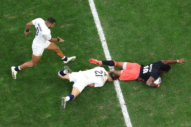 Vilimoni Botitu of Fiji scores his team's third try during the Rugby World Cup.