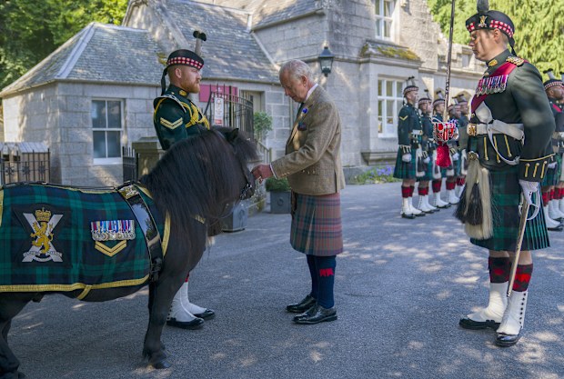 Britain's King Charles III meets Shetland pony Cpl Cruachan IV (mascot of the Royal Regiment of Scotland) during an inspection of the Balaklava Company, 5th Battalion, The Royal Regiment of Scotland, at the gates of Balmoral, in Aberdeenshire, Scotland, Monday Aug. 18, 2025. (Jane Barlow/PA via AP)
