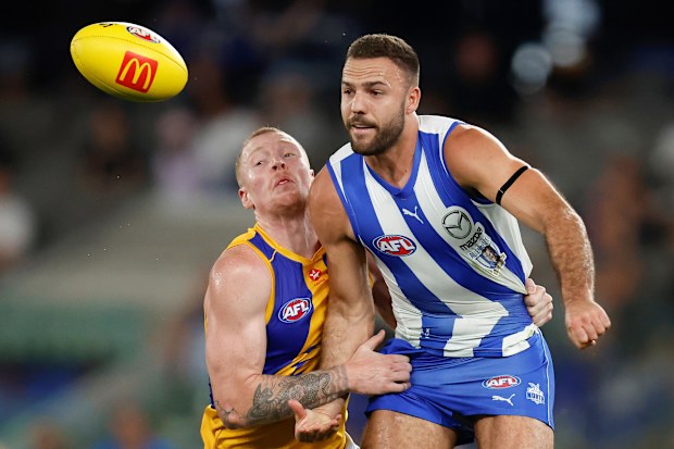 MELBOURNE, AUSTRALIA - MARCH 18: Griffin Logue of the Kangaroos is tackled by Bailey J. Williams of the Eagles during the 2023 AFL Round 01 match between the North Melbourne Kangaroos and the West Coast Eagles at Marvel Stadium on March 18, 2023 in Melbourne, Australia. (Photo by Michael Willson/AFL Photos)