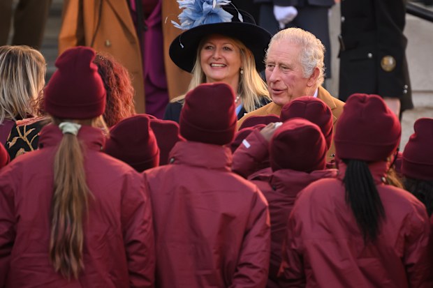 King Charles III speaks with school children as he visits Luton Town Hall on December 6, 2022 in Luton, England 