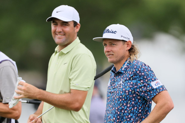 Scottie Scheffler and Cameron Smith of Australia wait on the 13th hole during the first round of the FedEx St. Jude Championship at TPC Southwind on August 11, 2022 in Memphis, Tennessee. (Photo by Andy Lyons/Getty Images)