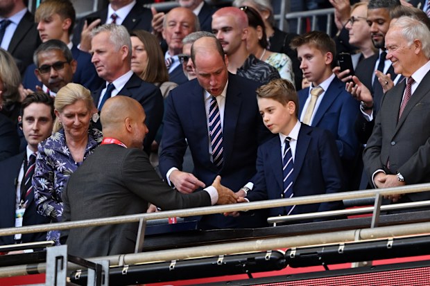 LONDON, ENGLAND - MAY 25: Prince George of Wales, shakes hands with Pep Guardiola, Manager of Manchester City, after the Emirates FA Cup Final match between Manchester City and Manchester United at Wembley Stadium on May 25, 2024 in London, England. (Photo by Mike Hewitt/Getty Images)