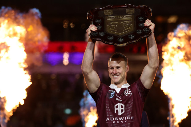 Daly Cherry-Evans of the Maroons holds aloft the State of Origin Shield after game three.