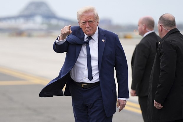 President Donald Trump points as he arrives at Newark Liberty International Airport in Newark, N.J., Saturday, April 26, 2025, upon returning from a trip to attend the funeral of Pope Francis at the Vatican. (AP Photo/Evan Vucci)