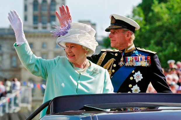 The Queen and the Duke of Edinburgh, Prince Philip, wave to the crowd as they leave  the "Recollections Of World War II Commemoration Show" in 2005