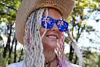 TAMWORTH, AUSTRALIA - JANUARY 26: Vicki Connors wears Australian Flag glasses while spending the long weekend camping by the Peel River during the Tamworth Country Music Festival on January 26, 2025 in Tamworth, Australia. On Australia Day, the Tamworth Country Music Festival culminates several days of music and celebration with vibrant live performances from numerous artists across many venues, showcasing the rich culture of Australian country music. Attendees can enjoy a lineup of talented mus