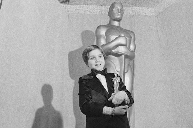 Tatum O'Neal holds the Oscar she won for working alongside her father in the movie Paper Moon. At 9 years old, O'Neal was one of the youngest Oscar winners ever.