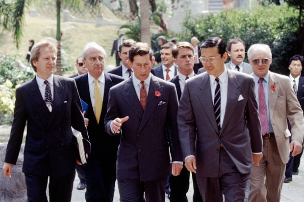 Prince Charles during a visit to Hong Kong in November 1992, accompanied by his press secretary, Dickie Arbiter (far right).