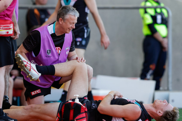 Port Adelaide's Todd Marshall was in agony as he was assessed for a hip inury against the Suns.