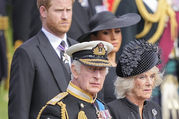 King Charles III, Camilla, the Queen Consort, Meghan, Duchess of Sussex, and Prince Harry watch as the coffin of Queen Elizabeth II is placed into the hearse following the state funeral service in Westminster Abbey in central London Monday Sept. 19, 2022. 
