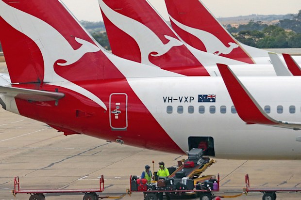 Baggage is loaded onto a Qantas jet at Melbourne Tullamarine Airport. 