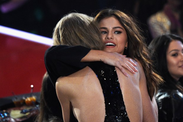 Recording artists Taylor Swift (L) and Selena Gomez hug during the iHeartRadio Music Awards at The Forum on April 3, 2016 in Inglewood, California. (Photo by Jason Kempin/Getty Images for iHeartRadio / Turner)