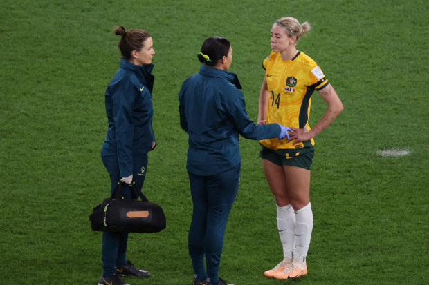 Alanna Kennedy receives medical attention after a head clash.