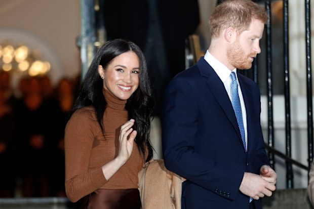 FILE - In this Tuesday, Jan. 7, 2020 file photo, Britain's Prince Harry and Meghan, Duchess of Sussex smile as they leave Canada House, in London. Prince Harry and his wife Meghan 'stepping back' as senior UK royals, will work to become financially independent, they announced Wednesday, Jan. 8, 2020.(Daniel Leal-Olivas/Pool Photo via AP, file)