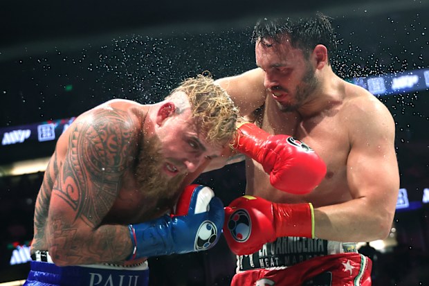 Julio Cesar Chavez Jr (right) punches Jake Paul on his way to losing.