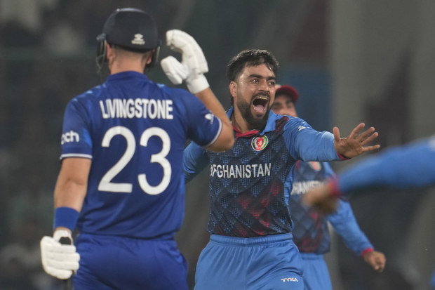 Afghanistan's Rashid Khan celebrates the wicket of England's Liam Livingstone.